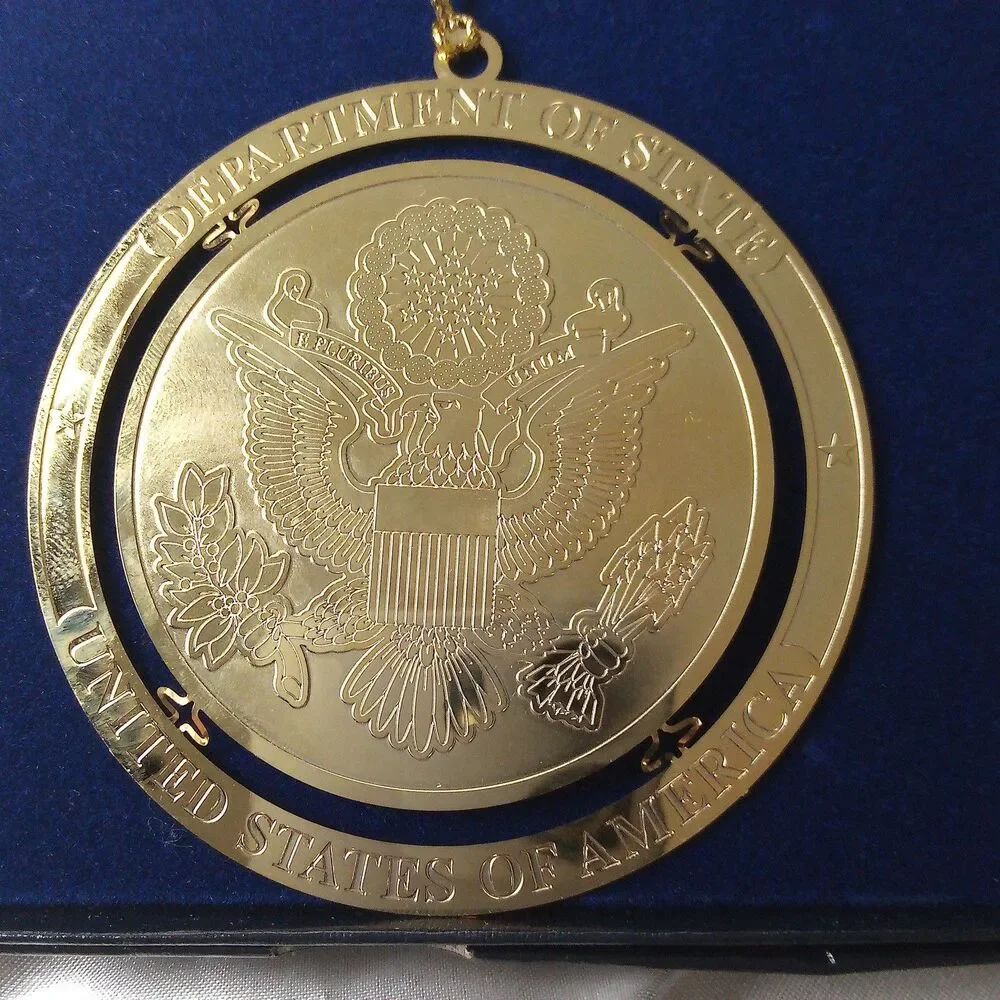 DEPARTMENT OF STATE GOLD TONE ORNAMENT IN BOX